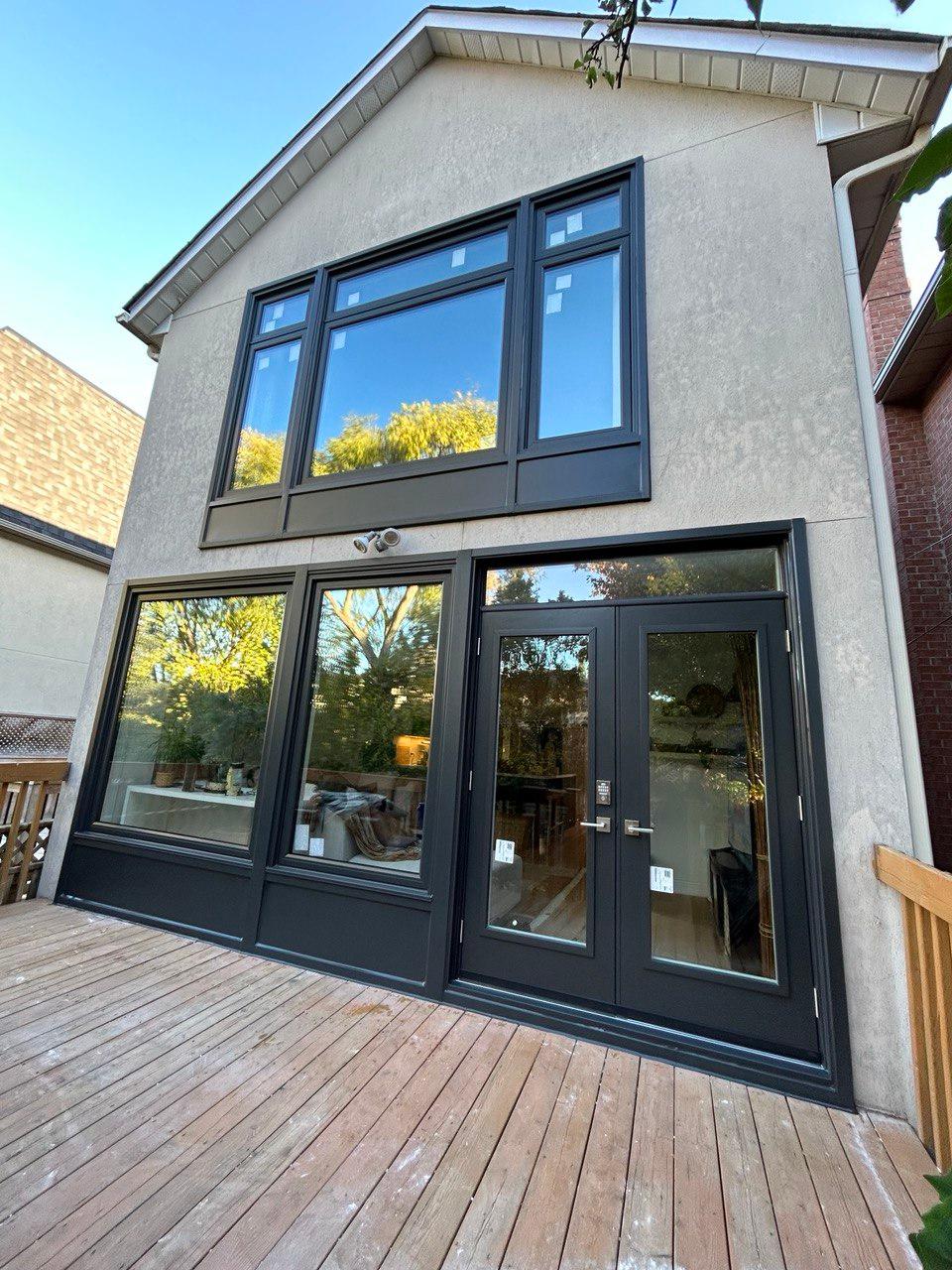 Exterior of a home with newly installed windows and an entry door