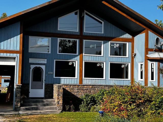 Exterior wall of a house with newly installed windows and an entry door