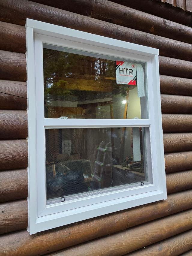 Newly installed windows in a log home wall
