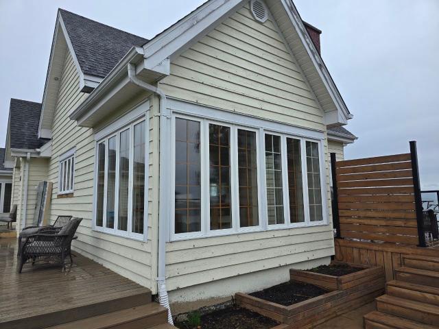 Exterior of a home with newly installed windows and doors